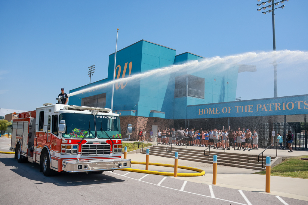 band camp being sprayed by fire truck
