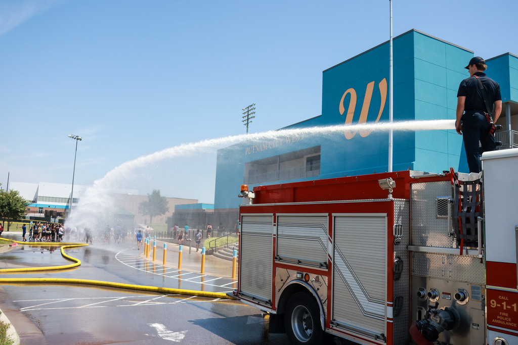 band camp being sprayed by fire truck