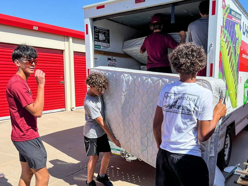 students loading items in truck