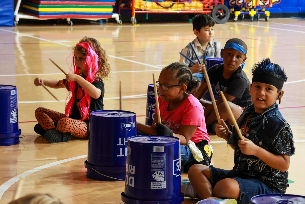 students playing bucket drums