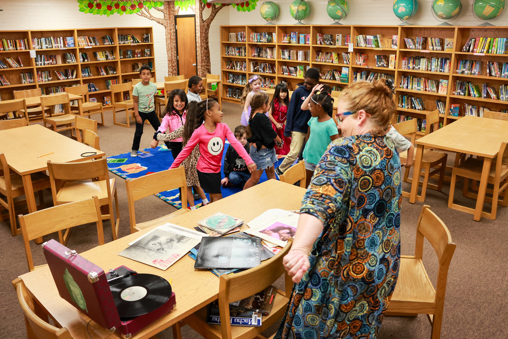 students dancing to record player